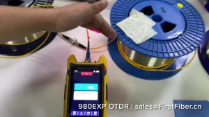 Hands-on instructional video for the FirstFiber 980EXP, featuring a live demonstration of bare fiber spool testing for telecom technicians